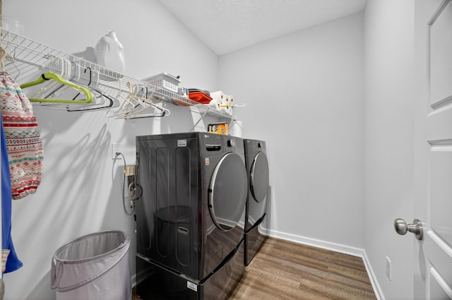 77 Frost St, Decherd, TN 37324 - washroom with washer and clothes dryer and wood finished floors