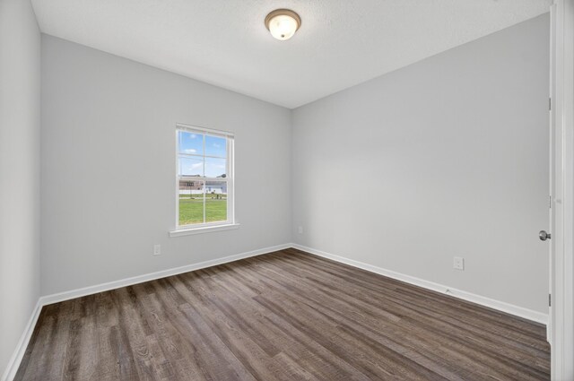 77 Frost St, Decherd, TN 37324 - empty room featuring dark wood-style floors and baseboards