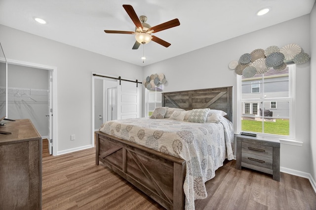 77 Frost St, Decherd, TN 37324 - bedroom featuring wood finished floors, a walk in closet, a barn door, a ceiling fan, and a closet