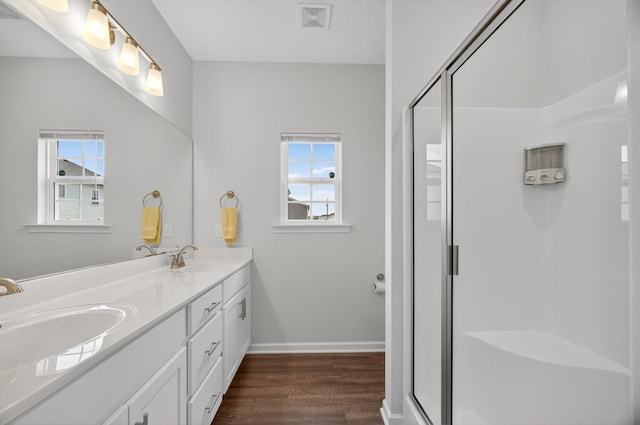 77 Frost St, Decherd, TN 37324 - full bath featuring wood finished floors, double vanity, healthy amount of natural light, and a shower stall