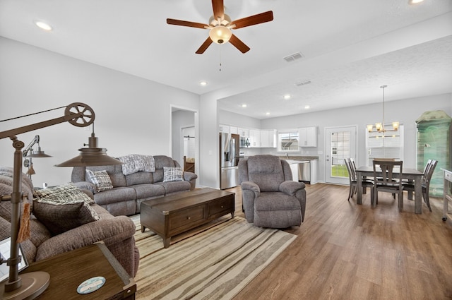 77 Frost St, Decherd, TN 37324 - living area featuring wood finished floors, a ceiling fan, recessed lighting, and a chandelier