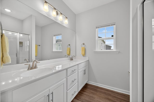 77 Frost St, Decherd, TN 37324 - bathroom featuring double vanity, wood finished floors, plenty of natural light, and a shower with door