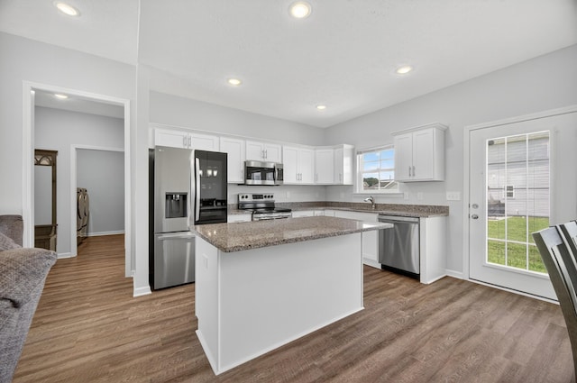77 Frost St, Decherd, TN 37324 - kitchen featuring appliances with stainless steel finishes, a kitchen island, white cabinets, dark wood-style floors, and recessed lighting