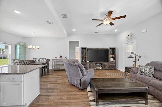 77 Frost St, Decherd, TN 37324 - living area with light wood finished floors, a ceiling fan, a chandelier, and recessed lighting