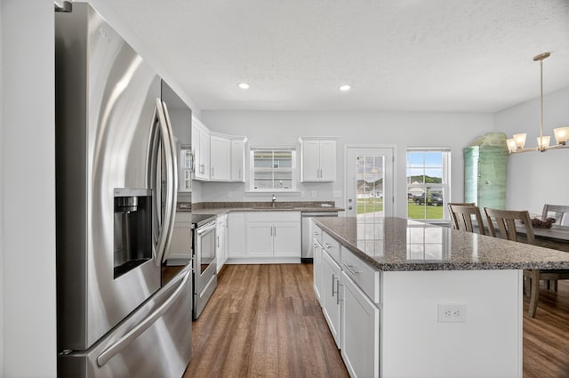 77 Frost St, Decherd, TN 37324 - kitchen with appliances with stainless steel finishes, a chandelier, wood finished floors, a kitchen island, and recessed lighting