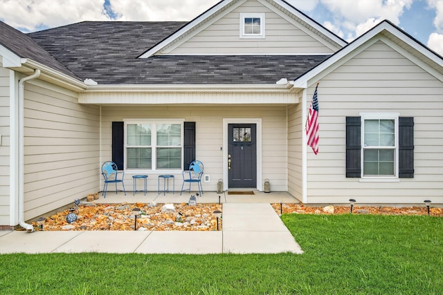 77 Frost St, Decherd, TN 37324 - view of exterior entry featuring a shingled roof, covered porch, and a yard