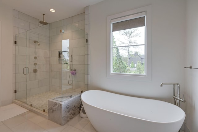 7555 Whiskey Rd, College Grove, TN 37046 - bathroom featuring a shower stall, a freestanding tub, tile patterned floors, and recessed lighting