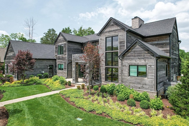 7555 Whiskey Rd, College Grove, TN 37046 - modern home with a chimney, a front lawn, roof with shingles, and a patio area