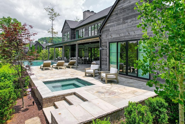 7555 Whiskey Rd, College Grove, TN 37046 - back of house featuring an in-ground hot tub, a patio area, an outdoor pool, and a chimney