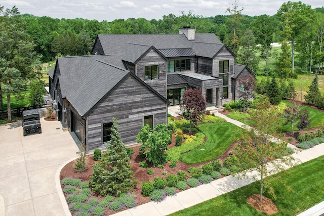 7555 Whiskey Rd, College Grove, TN 37046 - contemporary home with a standing seam roof, driveway, a chimney, a metal roof, and a shingled roof