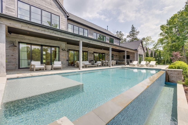 7555 Whiskey Rd, College Grove, TN 37046 - view of pool with an outdoor living space, a patio area, and an infinity pool