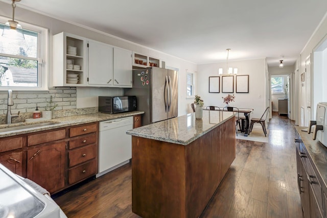 4985 Shihmen Dr, Antioch, TN 37013 - kitchen with white dishwasher, black microwave, plenty of natural light, crown molding, and open shelves