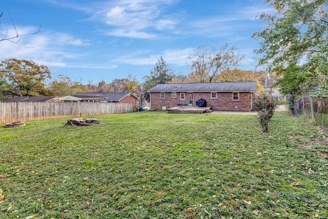4985 Shihmen Dr, Antioch, TN 37013 - fenced backyard featuring a fire pit and a wooden deck