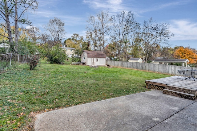 4985 Shihmen Dr, Antioch, TN 37013 - fenced backyard with a wooden deck, a storage unit, and a patio