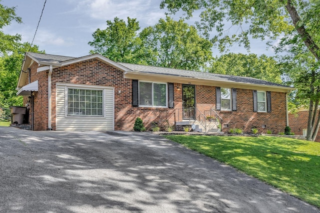 4985 Shihmen Dr, Antioch, TN 37013 - view of front of house featuring brick siding, a front lawn, and asphalt driveway