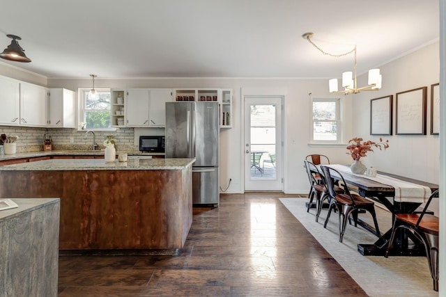 4985 Shihmen Dr, Antioch, TN 37013 - kitchen featuring freestanding refrigerator, open shelves, crown molding, a chandelier, and black microwave