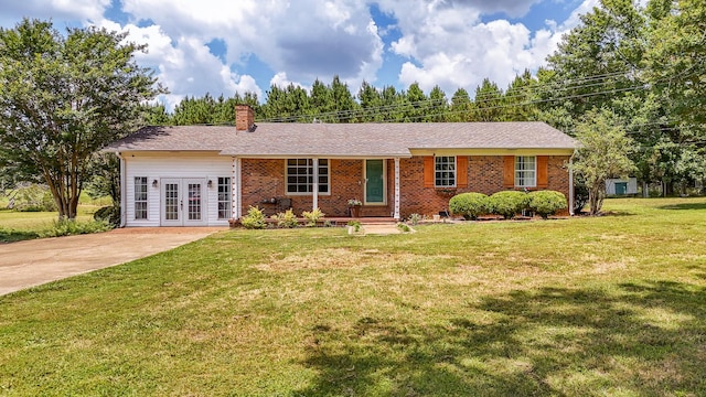 996 Matrose Carrolls Rd, Michie, TN 38357 - ranch-style home featuring french doors, a chimney, a front yard, brick siding, and driveway