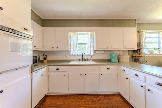 996 Matrose Carrolls Rd, Michie, TN 38357 - kitchen with white appliances, crown molding, decorative backsplash, dark wood-style floors, and white cabinetry