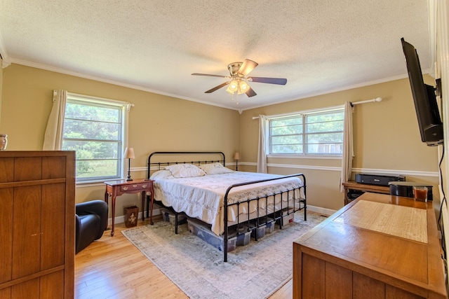 996 Matrose Carrolls Rd, Michie, TN 38357 - bedroom featuring light wood-style flooring, ornamental molding, a textured ceiling, and ceiling fan