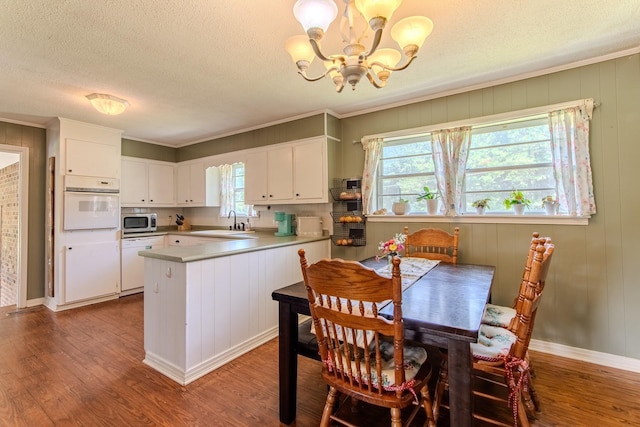 996 Matrose Carrolls Rd, Michie, TN 38357 - dining area featuring a chandelier, wood finished floors, a textured ceiling, and ornamental molding