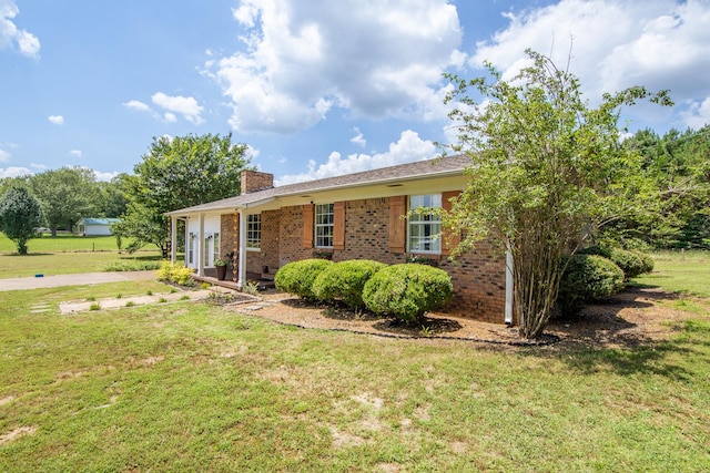 996 Matrose Carrolls Rd, Michie, TN 38357 - view of front of property with a chimney, a front yard, and brick siding