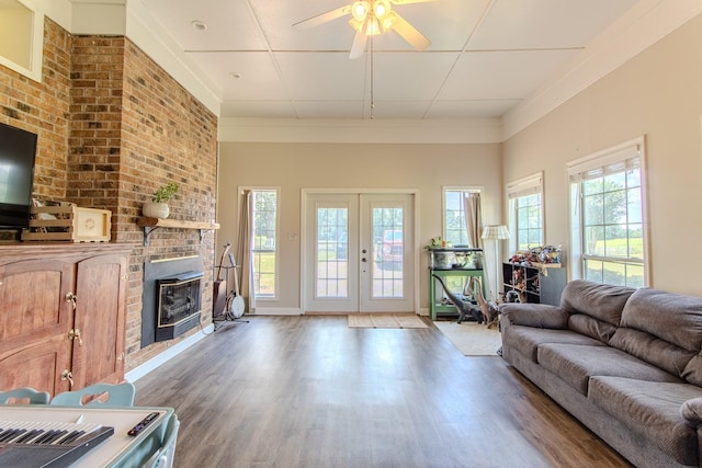 996 Matrose Carrolls Rd, Michie, TN 38357 - living room with wood finished floors, ceiling fan, a brick fireplace, and french doors