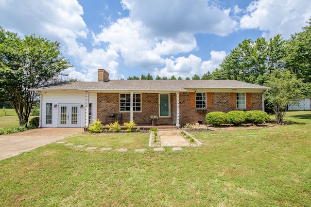 996 Matrose Carrolls Rd, Michie, TN 38357 - ranch-style home with french doors, a chimney, a front yard, and brick siding