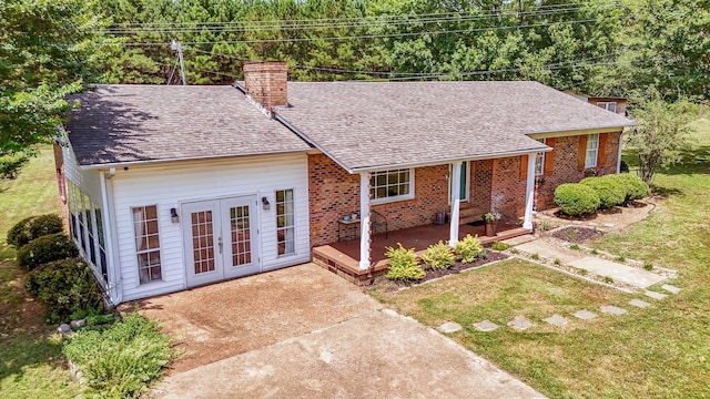 996 Matrose Carrolls Rd, Michie, TN 38357 - ranch-style house with a chimney, french doors, a front lawn, a shingled roof, and brick siding