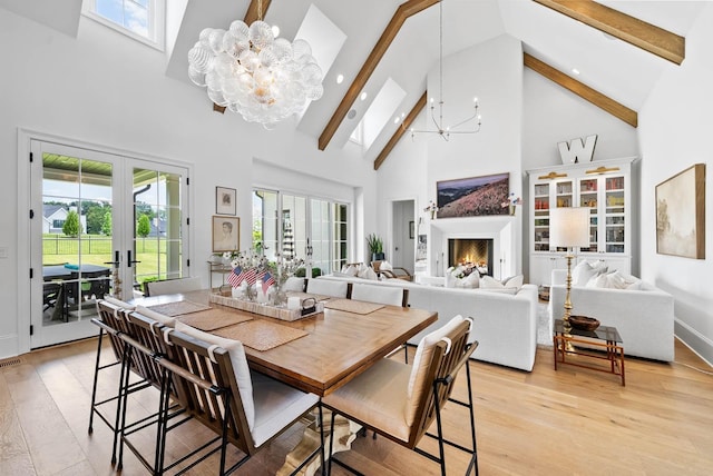 8869 Edgecomb Dr, College Grove, TN 37046 - dining room featuring a chandelier, high vaulted ceiling, beam ceiling, light wood-style floors, and french doors