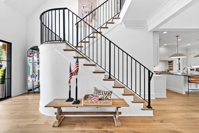 8869 Edgecomb Dr, College Grove, TN 37046 - staircase featuring wood finished floors, ornamental molding, recessed lighting, and a towering ceiling