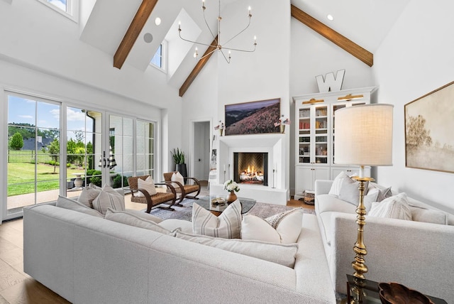 8869 Edgecomb Dr, College Grove, TN 37046 - living area featuring high vaulted ceiling, a chandelier, beamed ceiling, a lit fireplace, and wood finished floors