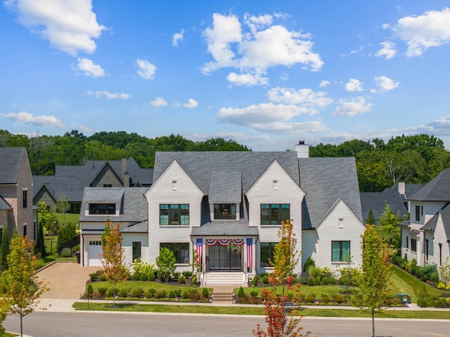 8869 Edgecomb Dr, College Grove, TN 37046 - view of front of property with driveway, a chimney, an attached garage, and a residential view