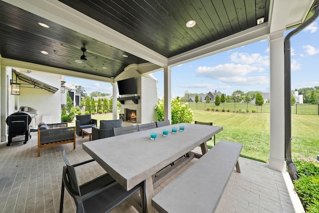 8869 Edgecomb Dr, College Grove, TN 37046 - view of patio with outdoor dining space, ceiling fan, and an outdoor living space with a fireplace