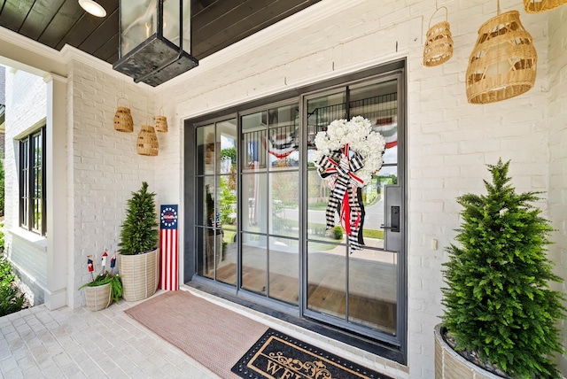 8869 Edgecomb Dr, College Grove, TN 37046 - view of exterior entry with a porch and brick siding