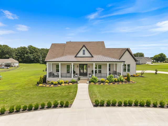 2157 Abiff Rd, Burns, TN 37029 - country-style home featuring covered porch, a standing seam roof, a front yard, and a metal roof