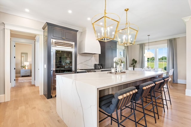 2157 Abiff Rd, Burns, TN 37029 - kitchen with built in fridge, a chandelier, light stone countertops, ornamental molding, and recessed lighting