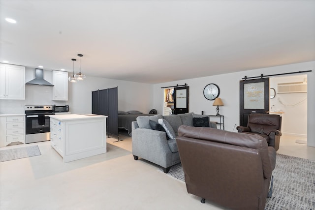 2157 Abiff Rd, Burns, TN 37029 - living area featuring a barn door, a wall unit AC, and recessed lighting