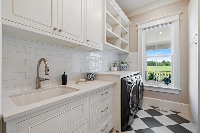 2157 Abiff Rd, Burns, TN 37029 - washroom featuring separate washer and dryer, cabinet space, tile patterned floors, and crown molding
