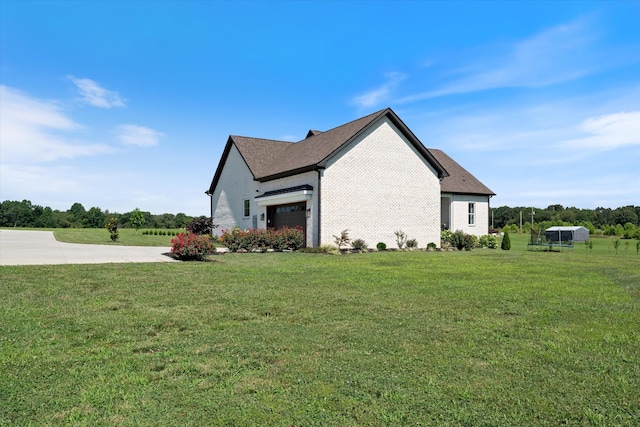 2157 Abiff Rd, Burns, TN 37029 - view of side of property with a lawn, a garage, and brick siding