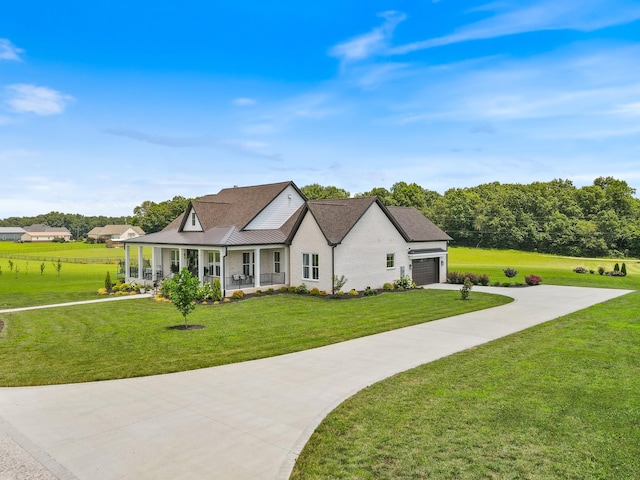 2157 Abiff Rd, Burns, TN 37029 - view of front facade with covered porch, concrete driveway, a front yard, an attached garage, and roof with shingles