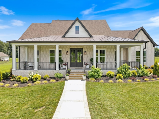 2157 Abiff Rd, Burns, TN 37029 - view of front facade featuring a standing seam roof, covered porch, and brick siding