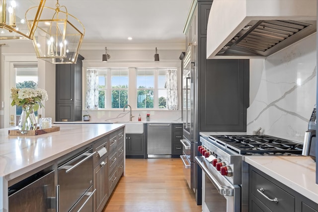 2157 Abiff Rd, Burns, TN 37029 - kitchen featuring premium range hood, premium appliances, a chandelier, backsplash, and light stone countertops