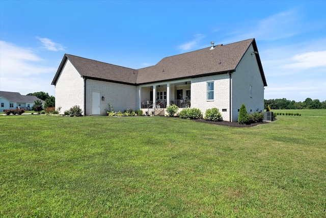 2157 Abiff Rd, Burns, TN 37029 - rear view of property with a yard, brick siding, and a ceiling fan