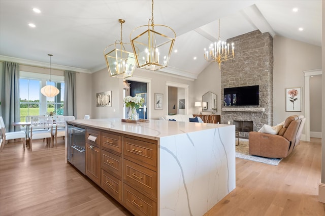 2157 Abiff Rd, Burns, TN 37029 - kitchen featuring a chandelier, light wood-style flooring, light stone counters, decorative light fixtures, and a fireplace