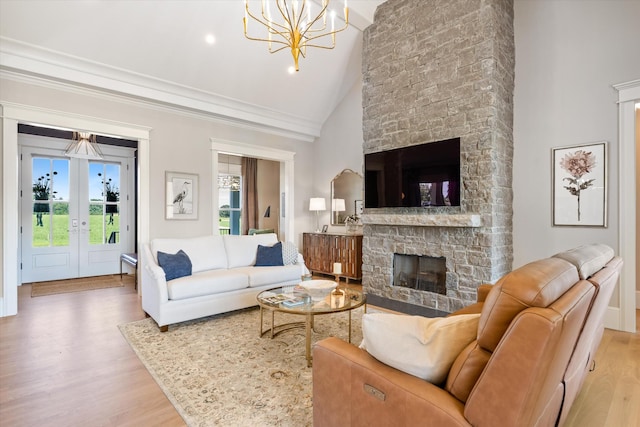 2157 Abiff Rd, Burns, TN 37029 - living room with a stone fireplace, wood finished floors, a chandelier, and high vaulted ceiling