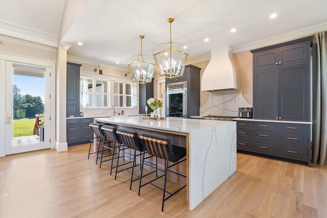 2157 Abiff Rd, Burns, TN 37029 - kitchen featuring premium range hood, a chandelier, a kitchen bar, ornamental molding, and a large island