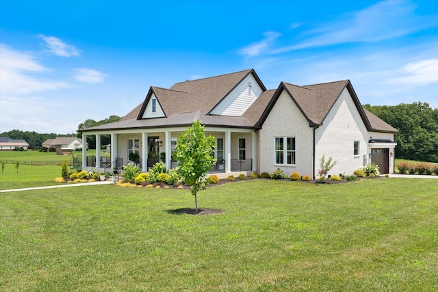 2157 Abiff Rd, Burns, TN 37029 - view of front facade featuring covered porch, a front yard, and an attached garage