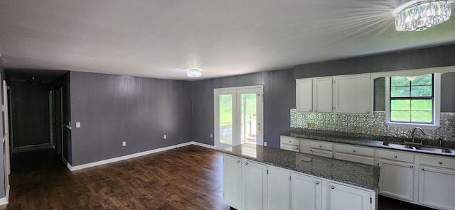 2877 Bryant Rd, Culleoka, TN 38451 - kitchen with white cabinetry, dark wood-type flooring, a kitchen island, and tasteful backsplash