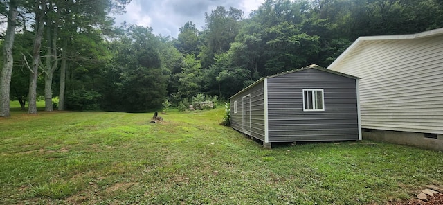 2877 Bryant Rd, Culleoka, TN 38451 - view of green lawn with a storage unit and a forest view
