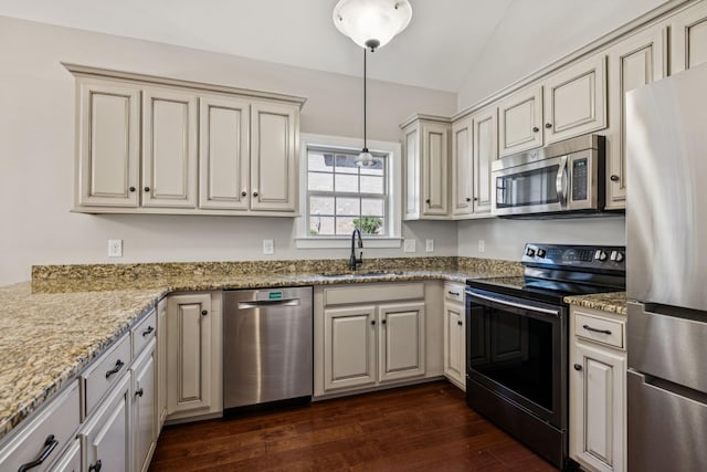 1037 Irish Way, Spring Hill, TN 37174 - kitchen with appliances with stainless steel finishes, dark wood-style flooring, lofted ceiling, cream cabinets, and light stone countertops